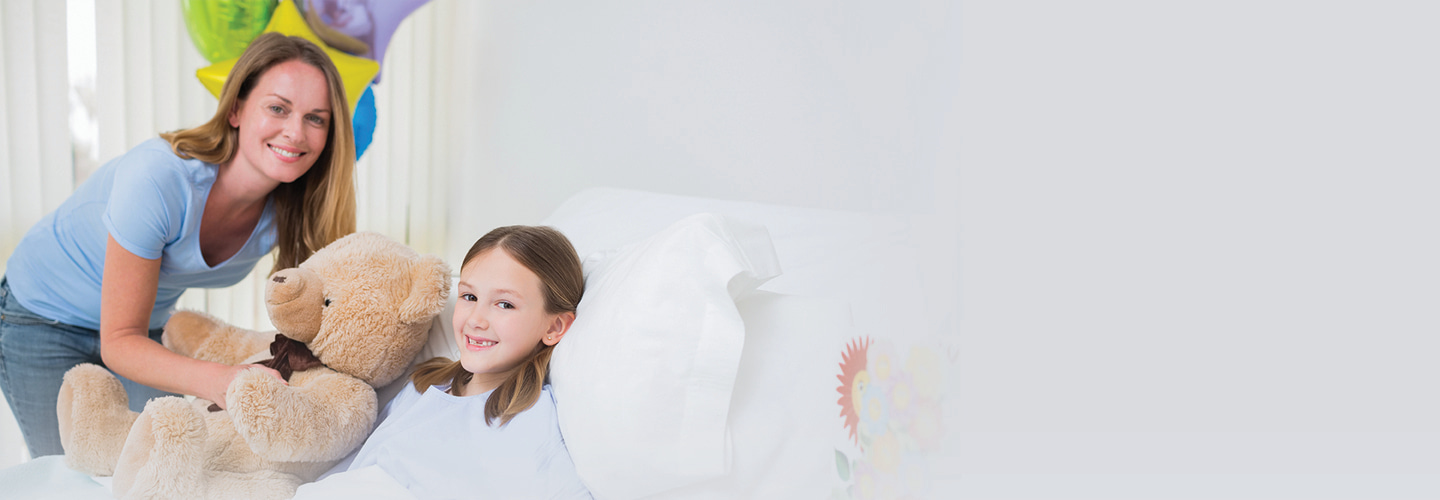 Girl receiving gifts in hospital bed